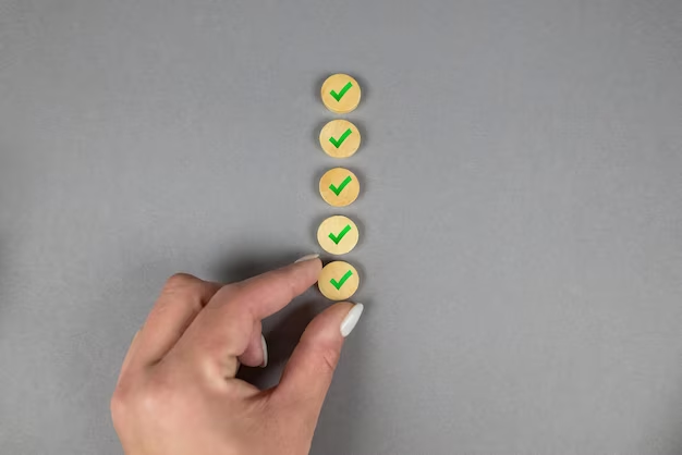 Hand stacking wooden circles with a green checkmark on each one