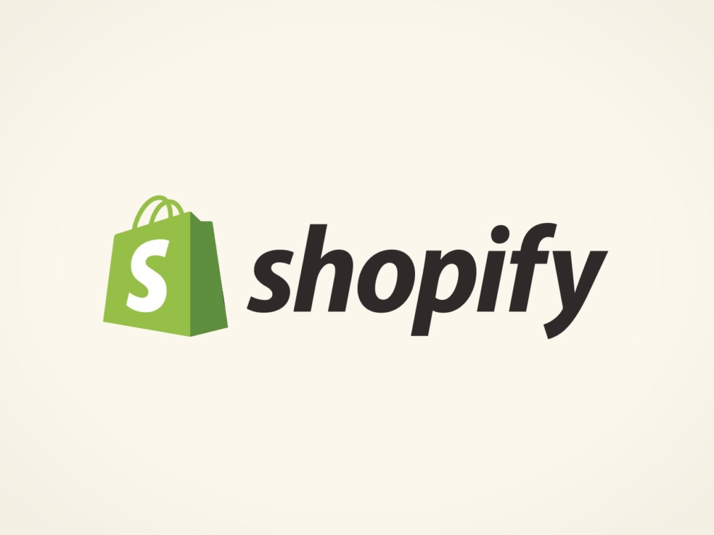 Green shopping bag with the letter 'S' and the word 'Shopify' beside it, forming the Shopify logo